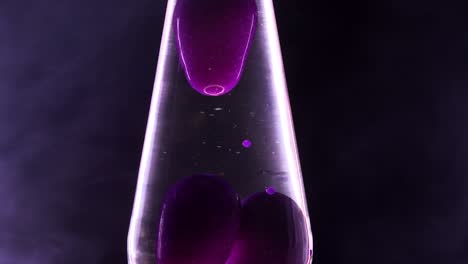 Close-up-of-a-purple-lava-lamp-with-cannabis-smoke-swirling-around-it