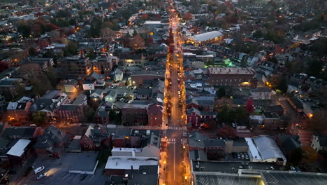 Reverse-dolly-aerial-establishing-shot-of-urban-city-at-night