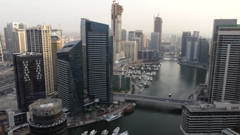 Boats-And-Yachts-Moored-At-Dubai-Marina-With-High-rise-Apartment-Buildings-And-Hotels