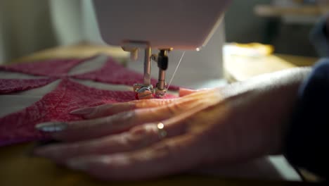 Stitching-the-decorative-and-intricate-quilt-block-pieces-together-on-a-sewing-machine---isolated-close-up