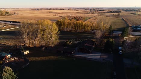Small-farm-properties-and-highway-14-near-Fort-Collins-Colorado-fall-2021-4K-drone-golden-light