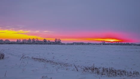 Vibrant-red-and-orange-sky-at-sunset-over-snow-covered-landscape