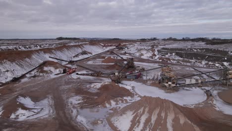 Aerial-View-of-Industrial-Gravel-Pit-Mining,-Front-End-Loader,-Machines,-Trucks---Dolly-Shot