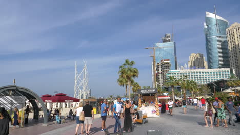 Tourists-Roaming-Around-Jumeirah-Beach-Residence-In-Dubai,-UAE-On-A-Sunny-Day