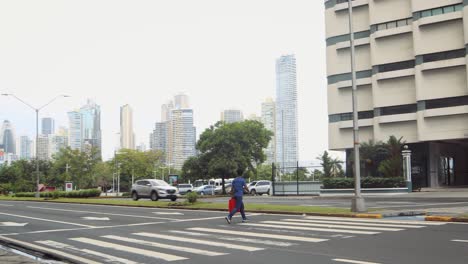 Pedestrian-crossing,-wearing-face-mask-during-COVID-19-pandemic,-Panama-City,-Panama