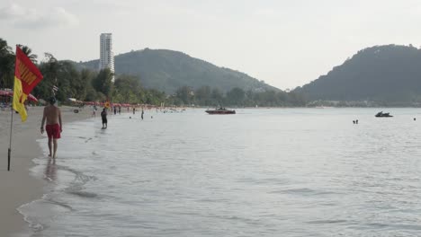 Patong-beach-with-many-people-relaxing-on-the-beach-while-in-covid19-omicron-outbreak-in-Phuket