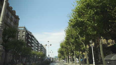 Beautiful-apartment-buildings-and-green-tree-alley-in-downtown-of-San-Sebastian
