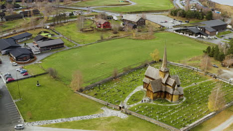 View-of-Lom-Stave-Church-,-Morning-scene-of-Norwegian-countryside,-administrative-centre-of-Lom-municipality---aerial-drone-shot