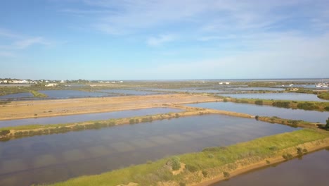 4K-Aerial-Footage-Over-Fuseta-in-the-South-of-Portugal-with-Mudflats-Filled-with-Water