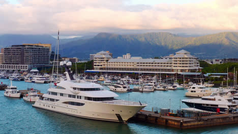 Superyacht-And-Boats-Docked-In-Front-Of-Shangri-la-The-Marina-Hotel-In-Cairns-City,-Australia