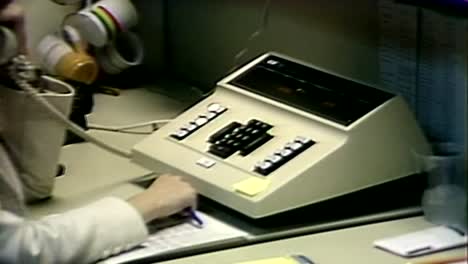 1981-WOMAN-USING-DIGITAL-TRANSMISSION-MULTI-LINE-PHONE-DEVICE