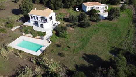 Daring-aerial-drone-flight-slowly-sinking-down-drone-shot-of-an-luxury-real-estate-villa-on-malibu-cliff-Paradise-wild-nature-dream-beach-Corfu-Greece-autumn-2021-Cinematic-1080-60p-by-Philipp-Marnitz