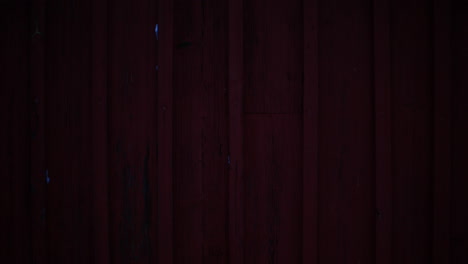 Time-lapse-of-shadows-on-red-wooden-wall-in-winter