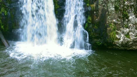 Waterfall-Reaching-a-Lake.-Drone-Footage,-Vertical-Motion