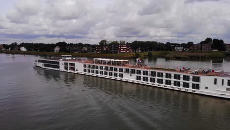 Aerial-Port-Side-View-Of-Viking-Ve-Cruise-Longship-Navigating-Along-River-Noord
