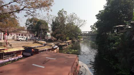 Boating-charming-canals-of-Kerala-backwaters,-Alappuzha,-India