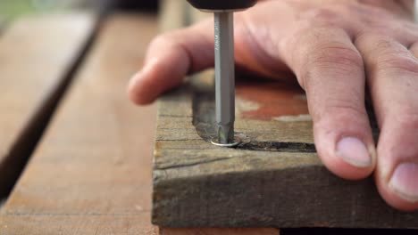Fastening-Screw-Into-Wood-Plank-With-A-Screwdriver