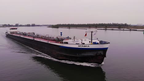 Aerial-Dolly-Towards-Forward-Bow-Of-Monika-Inland-Tanker-Ship-Navigating-Oude-Maas-On-Cloudy-Day