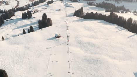 follow-drone-shot-of-lone-skier-on-a-long-ski-slope
