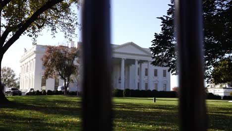 Tracking-Motion-through-gate-from-the-White-House-on-sunny-day,-garden-views,-Washington,-D
