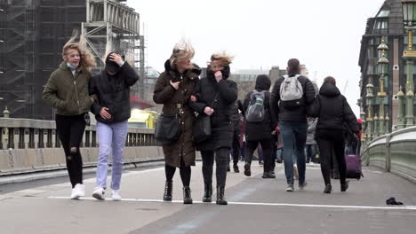 Women’s-hair-is-blown-about-as-people-walk-across-Westminster-Bridge-through-strong-winds-during-Storm-Eunice-in-slow-motion