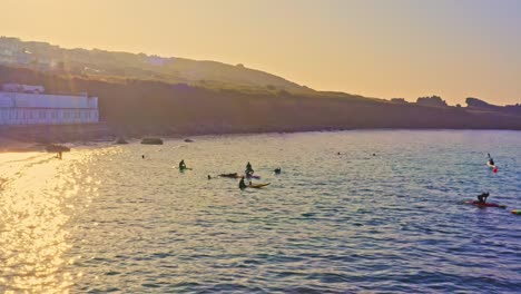 Magic-hour-surfer-community-chilling-at-Marazion-England-aerial