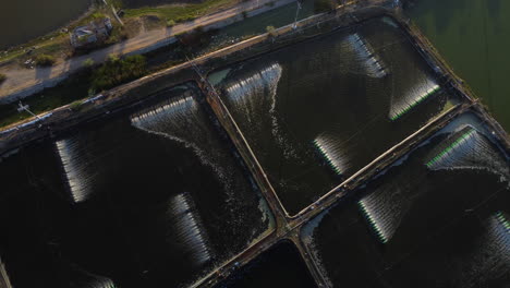 An-aerial-shot-made-over-a-shrimp-farm-aerators,-that-are-spinning