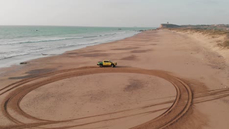 Yellow-Truck-Off-Roading-On-Beach-By-Sea-In-Balochistan