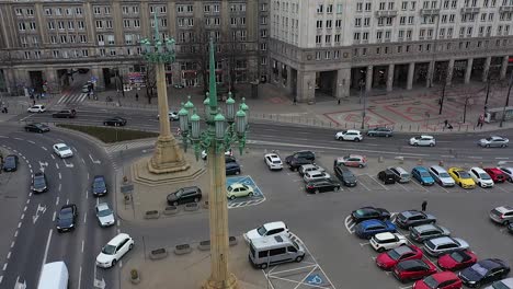 Aerial-view-around-a-traditional-street-light-with-traffic-in-the-background-in-Warsaw,-Poland---orbit,-drone-shot