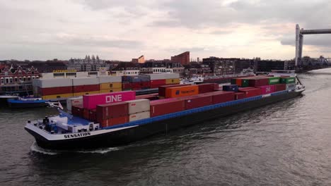 Aerial-Port-Side-View-Of-Sensation-Cargo-Container-Ship-Along-Oude-Maas-Leaving-Raised-Spoorbrug-Railway-Bridge