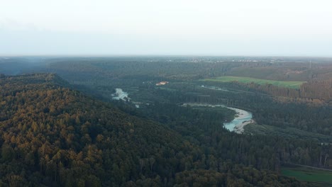 Aerial-view-over-the-winding-bavarian-Isar-river-behind-hills-of-bavaria