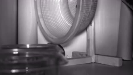 Night-vision-timelapse-of-hamster-running-in-the-hamster-wheel,-making-noise-and-keeping-people-awake
