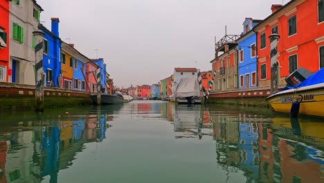 Unusual-and-different-low-angle-panoramic-view-of-Burano-colorful-houses-seen-from-canal-center,-Italy