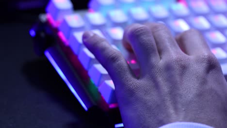 Young-man-hand-using-the-W,-A,-S,-D-keys-of-a-mechanical-keyboard-with-led-lights