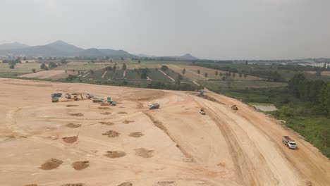 Construction-site-view-from-above,-Heavy-machinery-working-on-Countryside-field,-Thailand