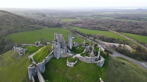 Aerial-panoramic-circling-view-over-Corfe-Castle-ruins-in-county-Dorset,-England