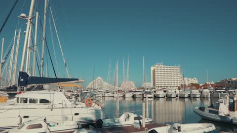 Parked-Grande-Mottes-Yacht-rocking-on-water-and-buildings-on-a-beautiful-day