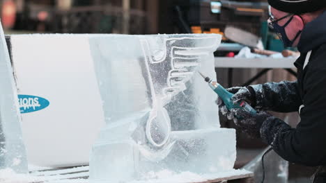 Artist-wearing-Covid-10-facemask-uses-Dremel-tool-to-shape-ice-sculpture