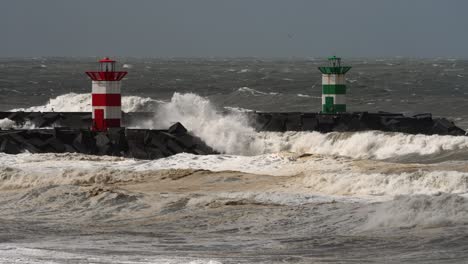 Powerful-rough-stormy-waves-crashing-in-promenade-with-lighthouse