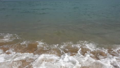 waves-crashing-on-beach-sand,-slow-motion