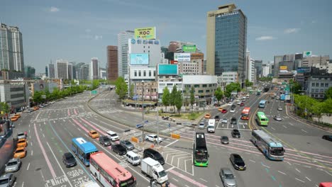 Busy-daytime-traffic-Near-Seoul-Station-on-Sejong-daero-road-against-cityscape-panorama---establishing-shot