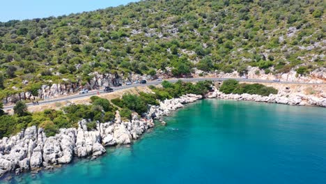 Beautiful-rocky-cove-alongside-a-coastal-road-in-Finike-Turkey-near-the-Mediterranean-Sea-on-a-sunny-summer-day