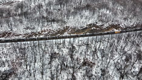 Norfolk-Southern-Railway-train-cars-transport-coal-from-mine-through-mountain-pass-in-winter-snow