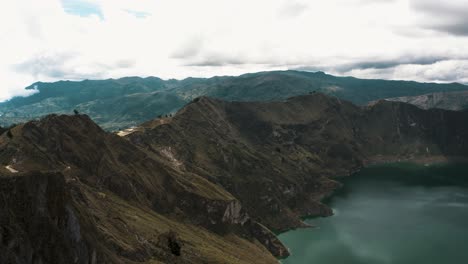 Hiking-Path-Along-The-Quilotoa-Loop-Around-The-Volcanic-Crater-Lake-In-Ecuador---aerial-drone-shot