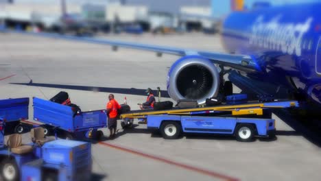 Timelapse-of-Southwest-Airlines-plane-loading-luggage-by-ground-crew-in-hangar-terminal-at-the-airport-3
