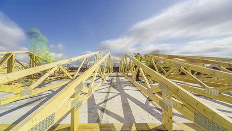 Workers-Constructing-Roof-Trusses-On-Sunny-And-Cloudy-Day