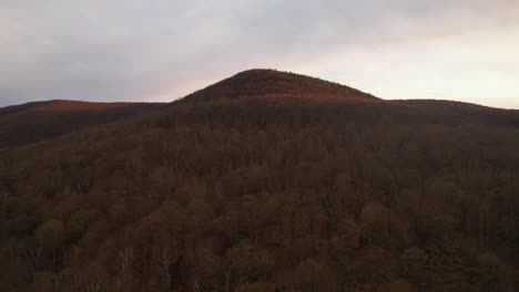 Aerial-drone-footage-of-a-red-and-gold-colored-sunset-golden-hour-in-the-Appalachian-mountains-during-autumn