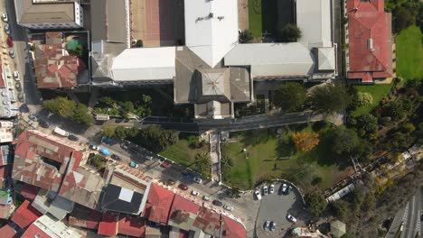 Aerial-top-down-lowering-on-National-Maritime-Museum-in-Cerro-Artilleria,-Valparaiso-hillside-city,-Chile