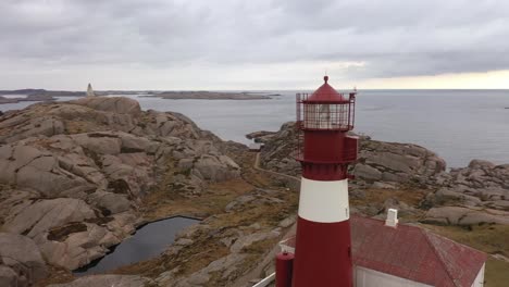 Ryvingen-lighthouse-rotating-and-backward-moving-aerial---From-closeup-of-lantern-to-full-view-of-installation-with-coastline-and-north-sea-in-background