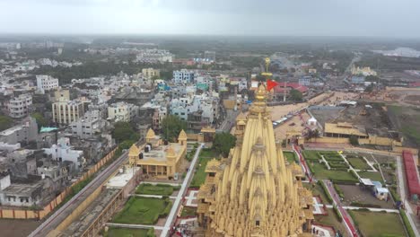 Aerial-drone-rotating-view-of-Somnath-temple-with-city-houses-view